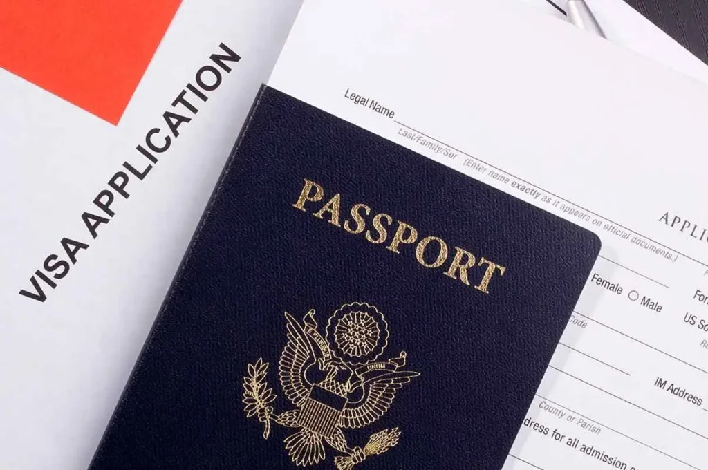 US passport against a Dubai visa application form.